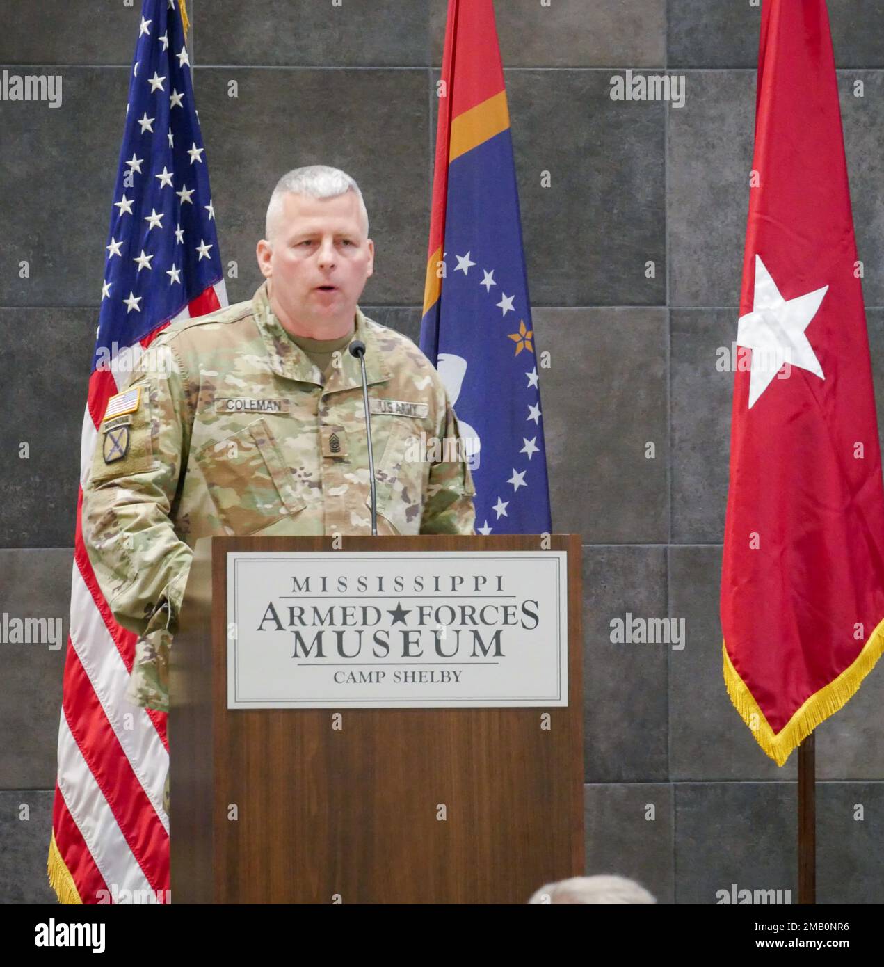 Command Sgt. Maj. Jonathan B. Coleman, incoming land component command sergeant major of the Mississippi National Guard, addresses the audience during a change of responsibility ceremony in the Mississippi Armed Forces Museum’s Grand Gallery, Camp Shelby Joint Forces Training Center, Mississippi, June 9, 2022. Stock Photo