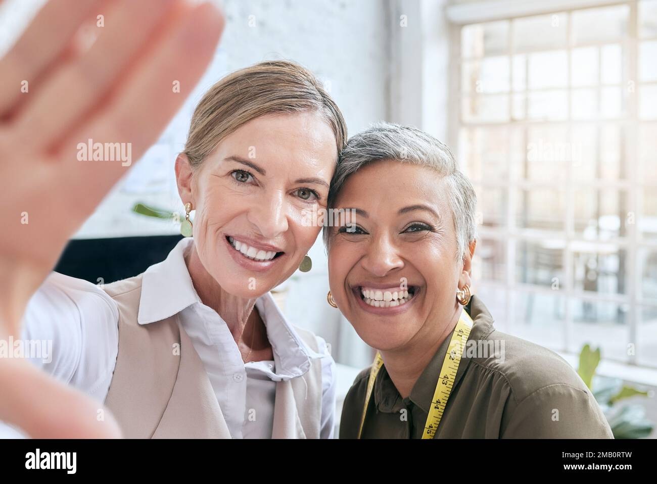 Fashion, designer and selfie of women in workshop taking pictures for happy memory. Face portrait, small business or senior female tailors taking Stock Photo
