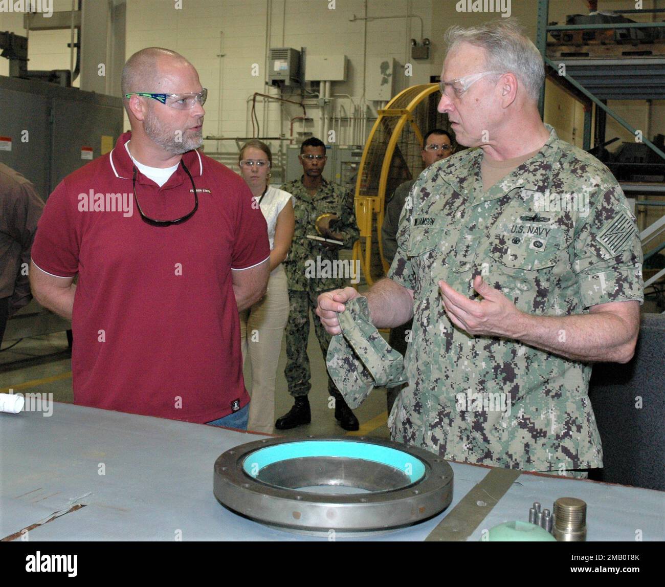 220608-N-WW980-0002 - KINGS BAY, Georgia - Scott Eels, General Foreman, Code 321, TRIDENT Refit Facility, Kings Bay (pictured left), briefs Vice Adm. Ricky Williamson, Deputy Chief of Naval Operations for Fleet Readiness and Logistics (OPNAV N4), (pictured right), about the Apprenticeship Program and the mission and capabilities of the Refit Industrial Facility (RIF) during a June 9, 2022, visit to Naval Submarine Base Kings Bay. Stock Photo