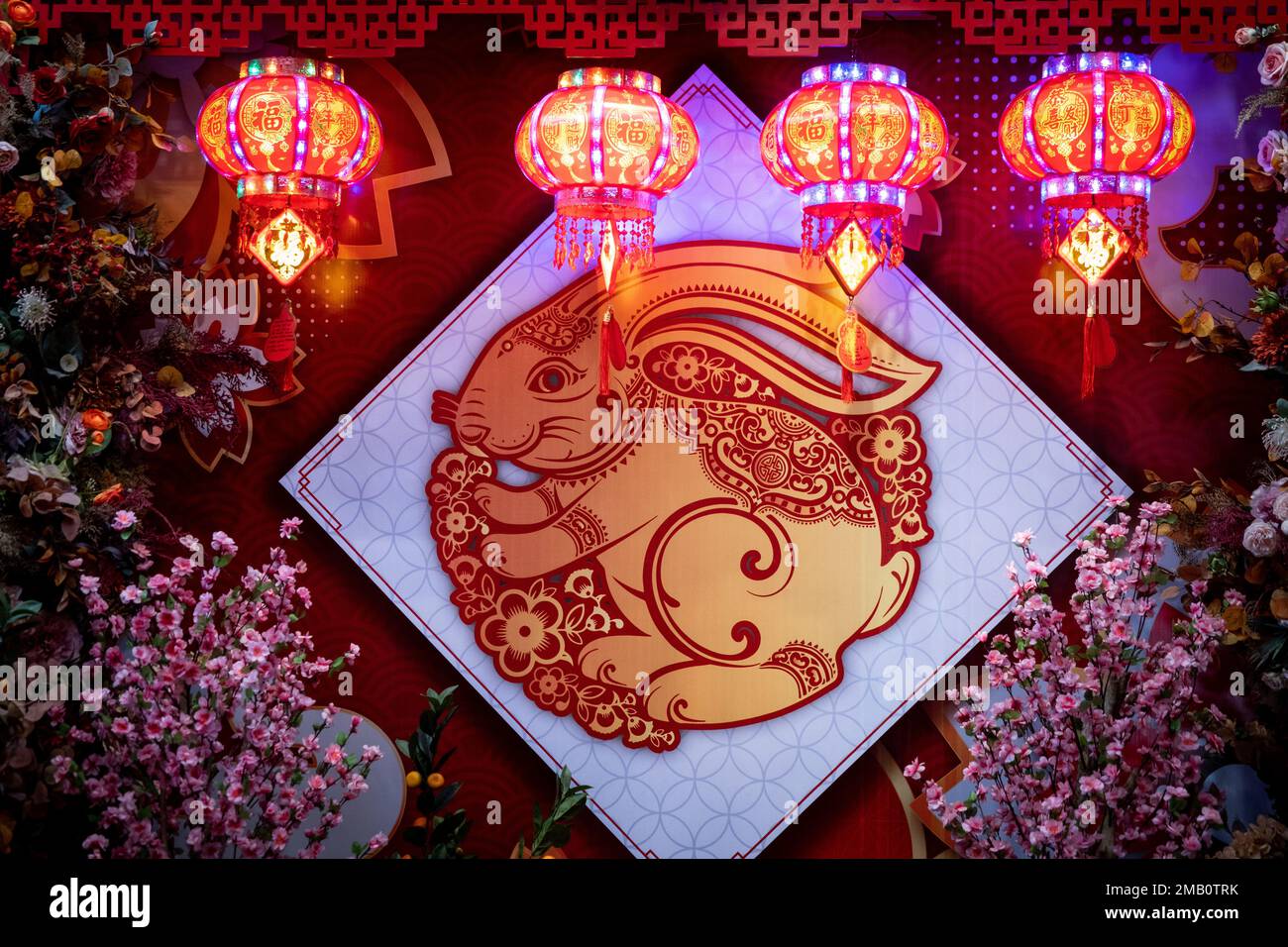 An orante rabbit is seen hanging beneath red chinese lanters at a ...