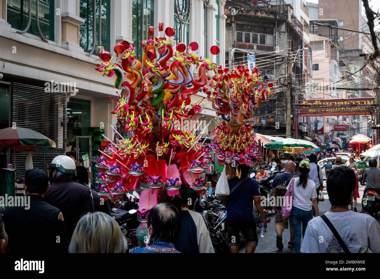 Vendors Carry Large Poles Of Chinese Paper Lanterns On The Street In vendors-carry-large-poles-of-chinese-paper-lanterns-on-the-street-in