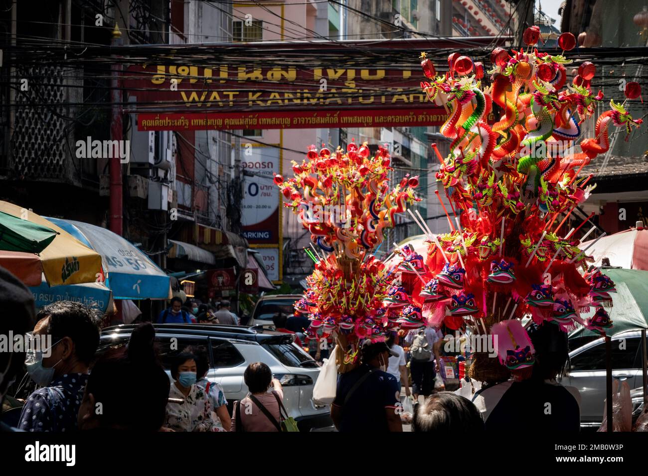 Vendors Carry Large Poles Of Chinese Paper Lanterns On The Street In vendors-carry-large-poles-of-chinese-paper-lanterns-on-the-street-in