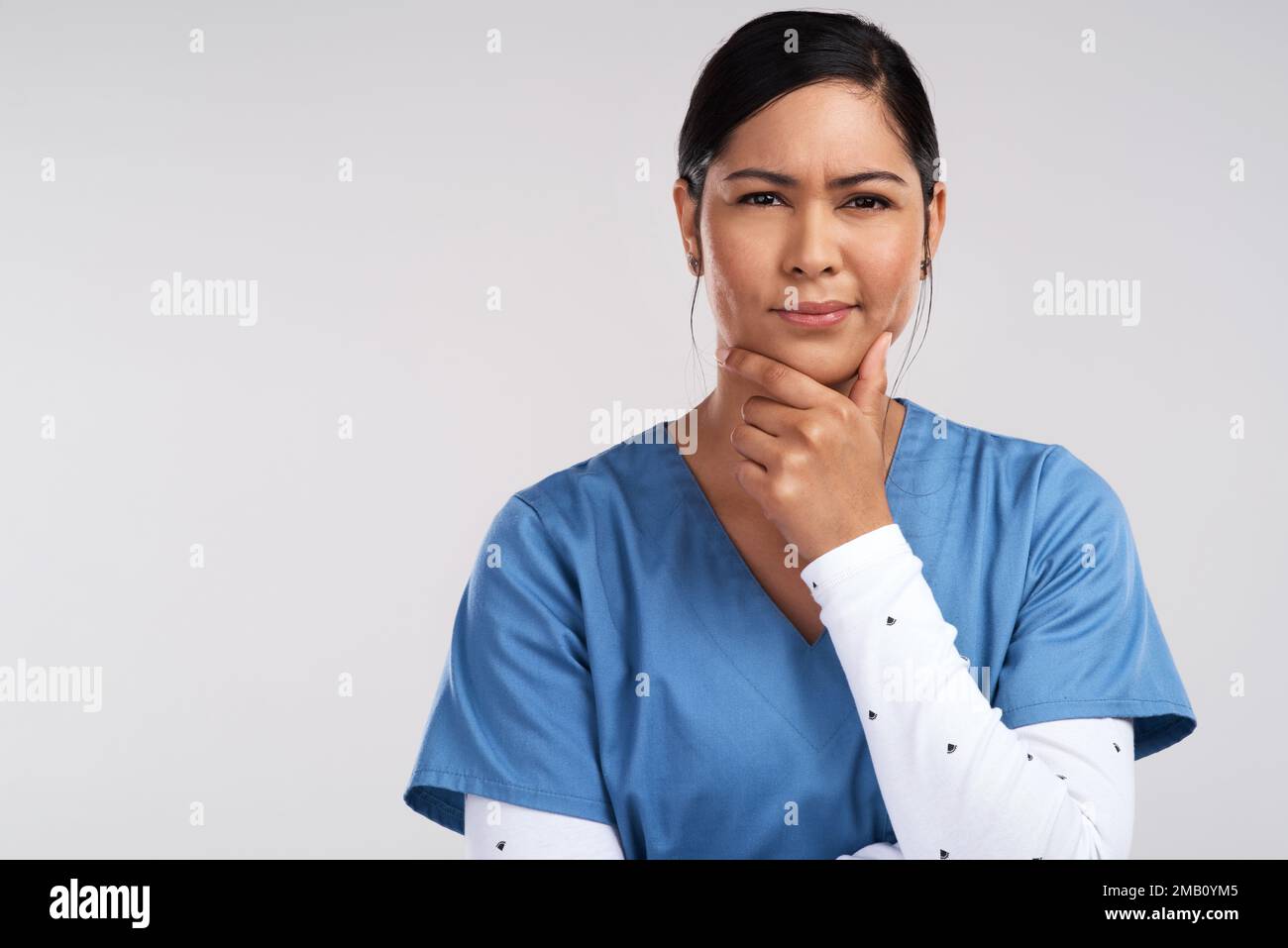 Synapse to synapse, Ill fatten possibilities. Portrait of a young beautiful doctor deep in thought against a white background. Stock Photo