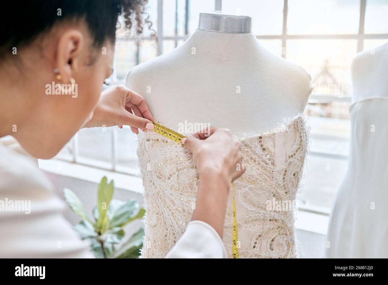 Fashion, designer and woman measuring dress on mannequin. Small