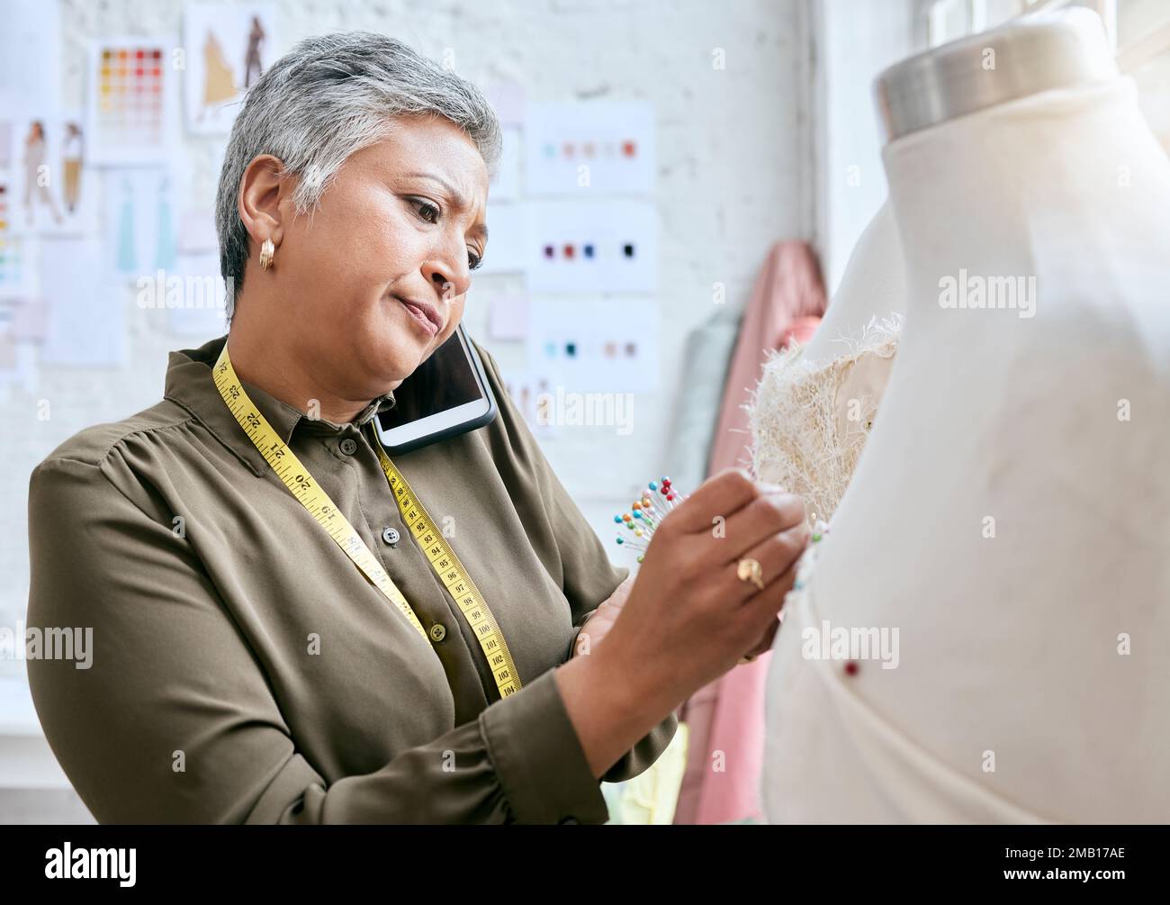Phone call, textile and senior woman with tailor, design process and fabric communication for client or business. Smartphone, boss, fashion designer Stock Photo