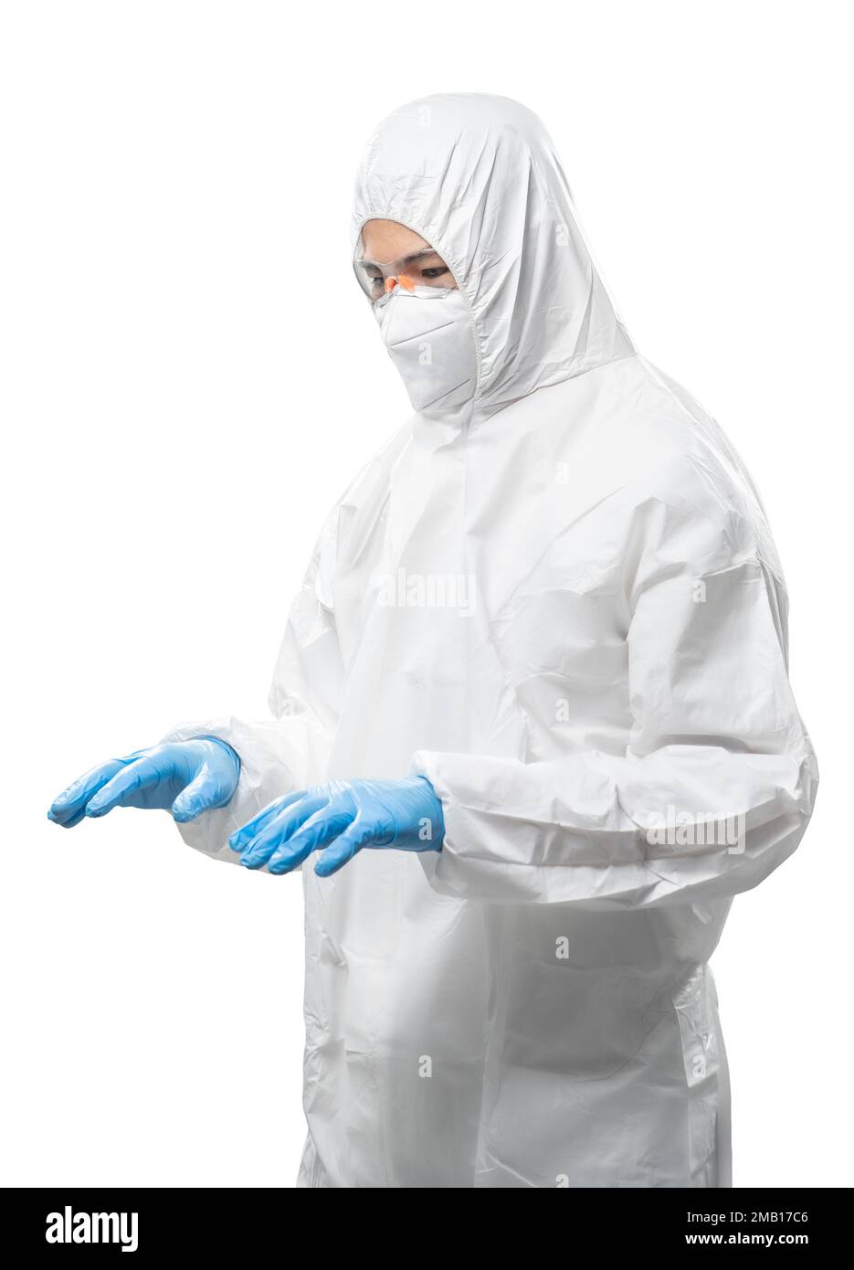 Worker wears medical protective suit or white coverall suit with mask and goggles empty hand typin isolated on white background Stock Photo