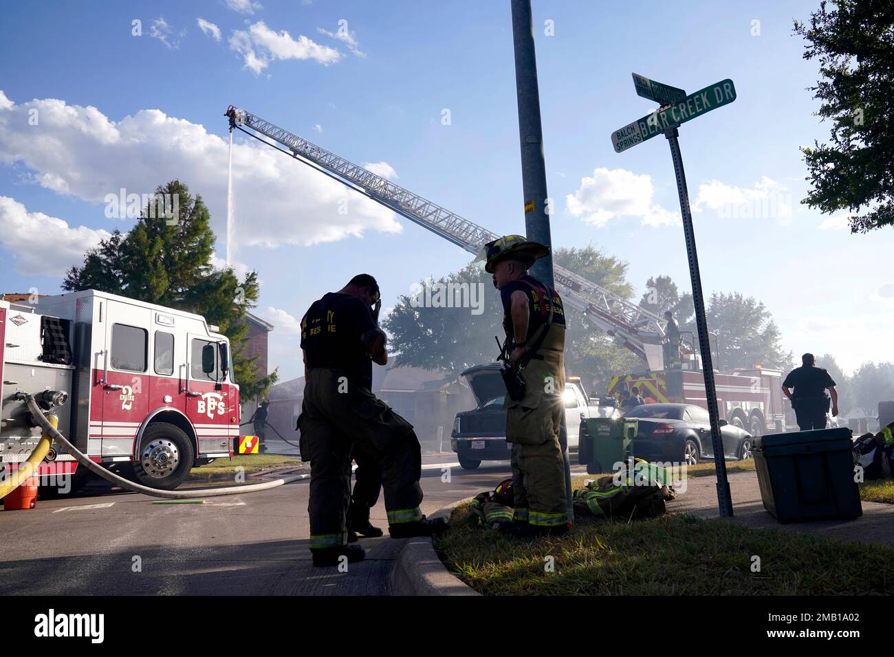 Firefighters from multiple departments work on putting out hot spots