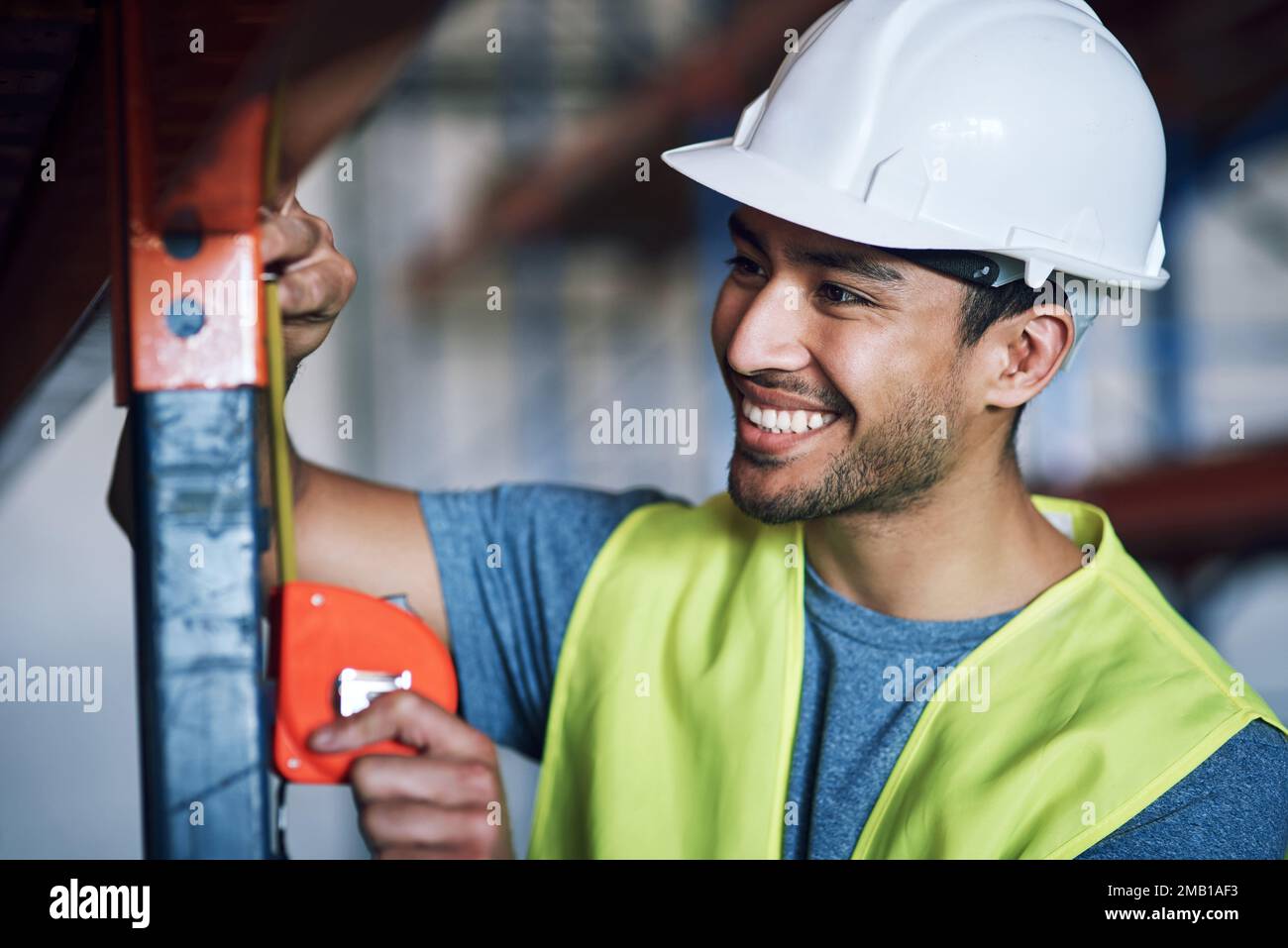 Builders Using Measure Nobody else measures up to his expertise. a young builder using a ...