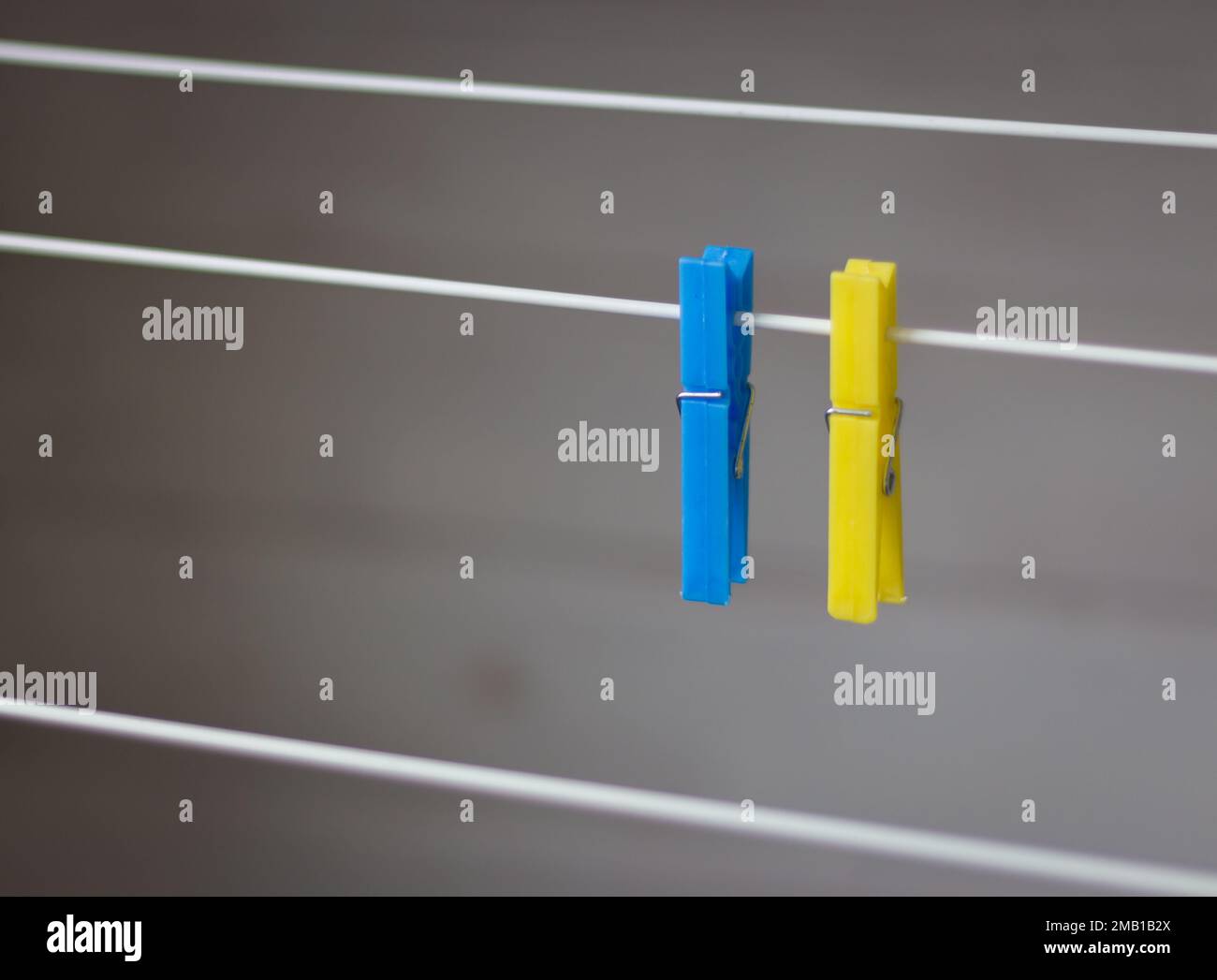 Clothing peg on washing line. Clothing pins on clothesline. Clothes pin in ukrainian colors. Blue and yellow peg. Laundry concept. Household equipment Stock Photo