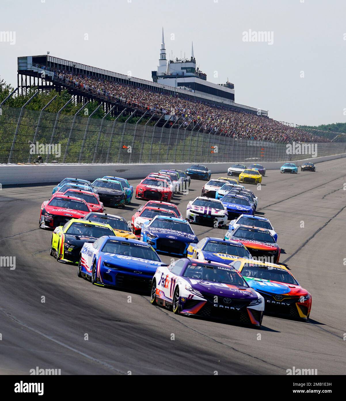 Denny Hamlin (11) leads the pack past the grandstand at the beginning of the NASCAR Cup