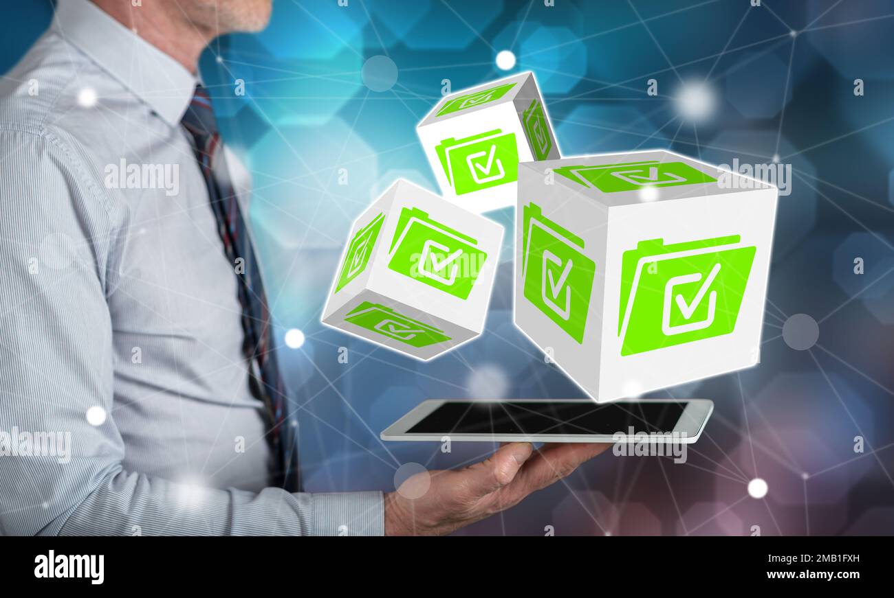 Document validation concept above a tablet held by a man Stock Photo