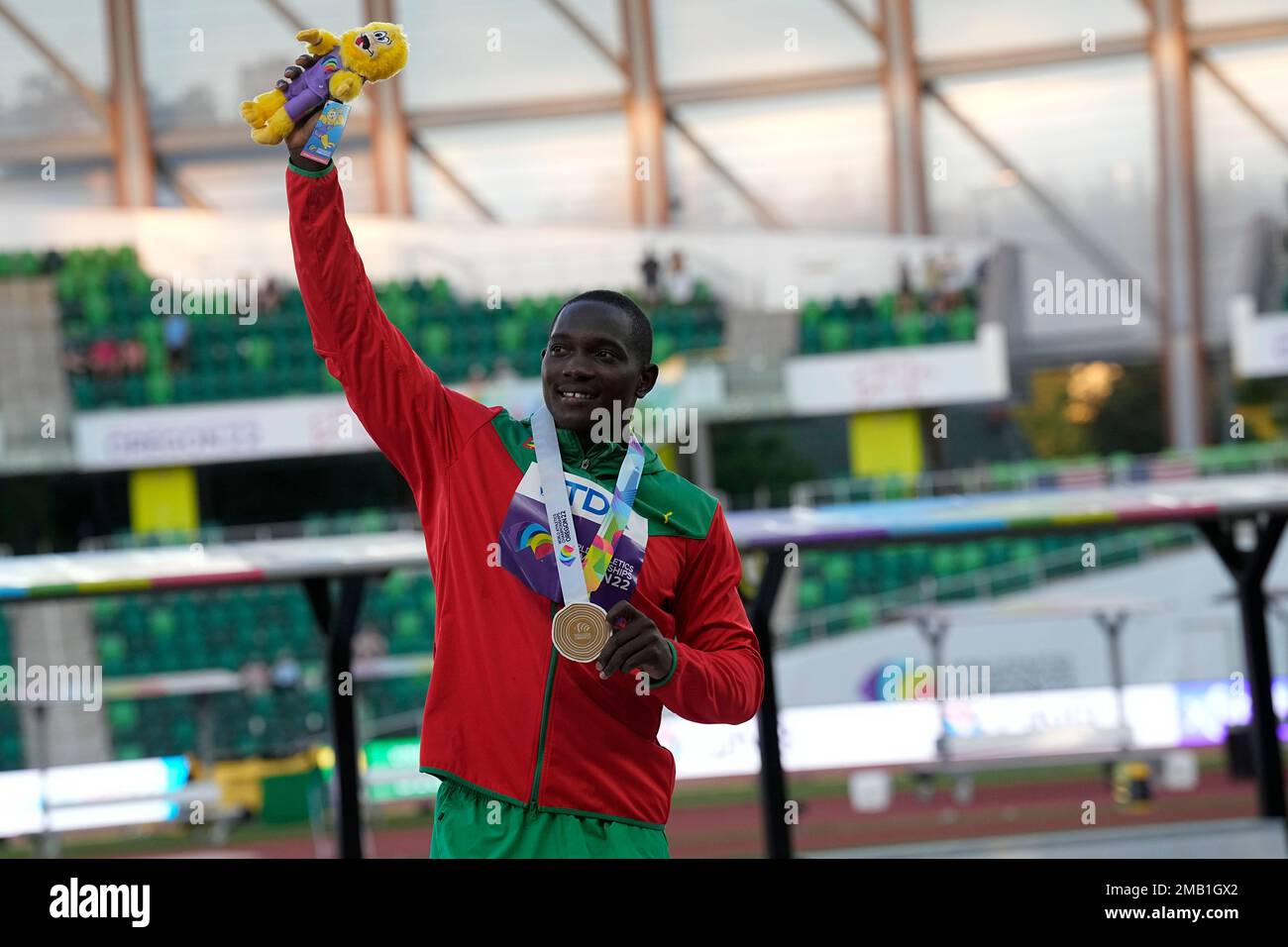 Gold medalist Anderson Peters, of Grenada, poses during a medal