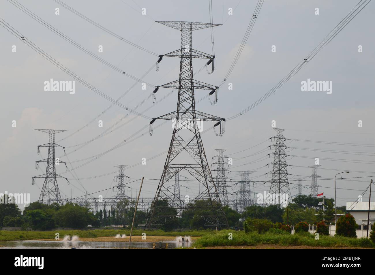 View of a row of high-voltage electric towers on a cloudy day Stock ...