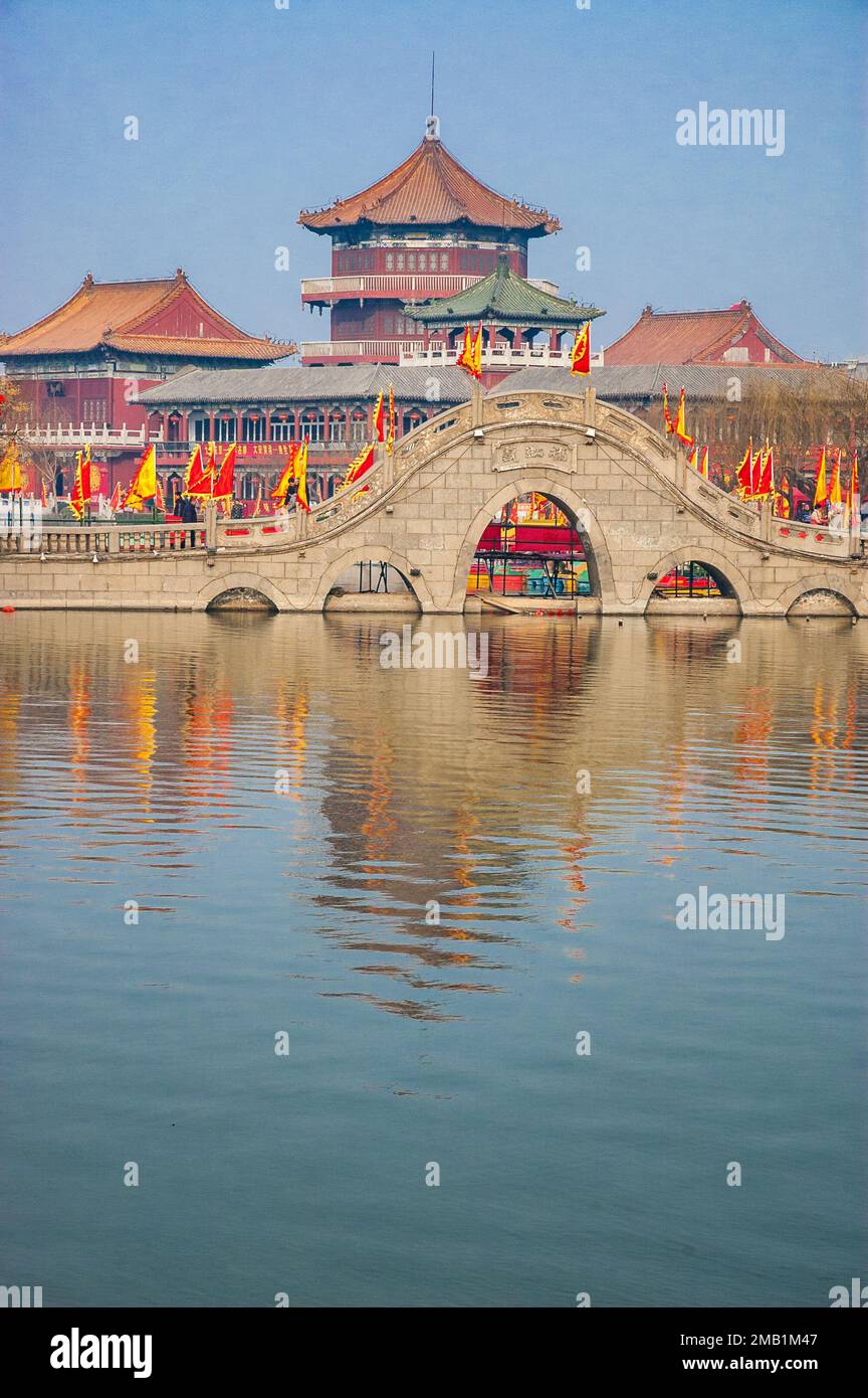 Stone bridge and traditional style buildings in Longting Park, Kaifeng, Henan Province, China. Stock Photo