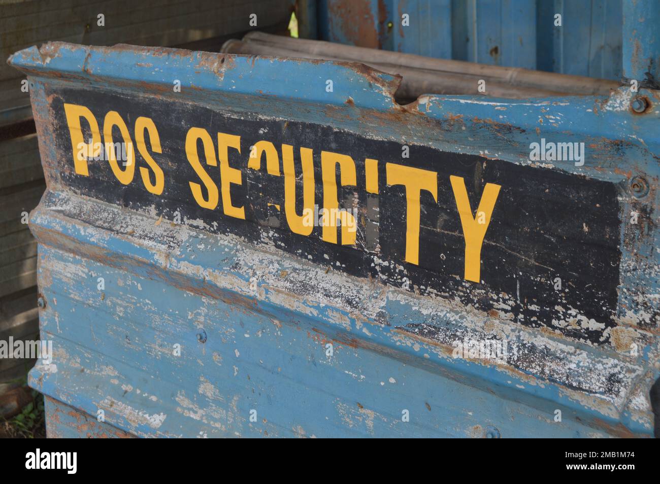 Portrait of an abandoned Security Post with the words POS SECURITY with some parts not intact. The post is built from zinc walls and bamboo frames. Stock Photo