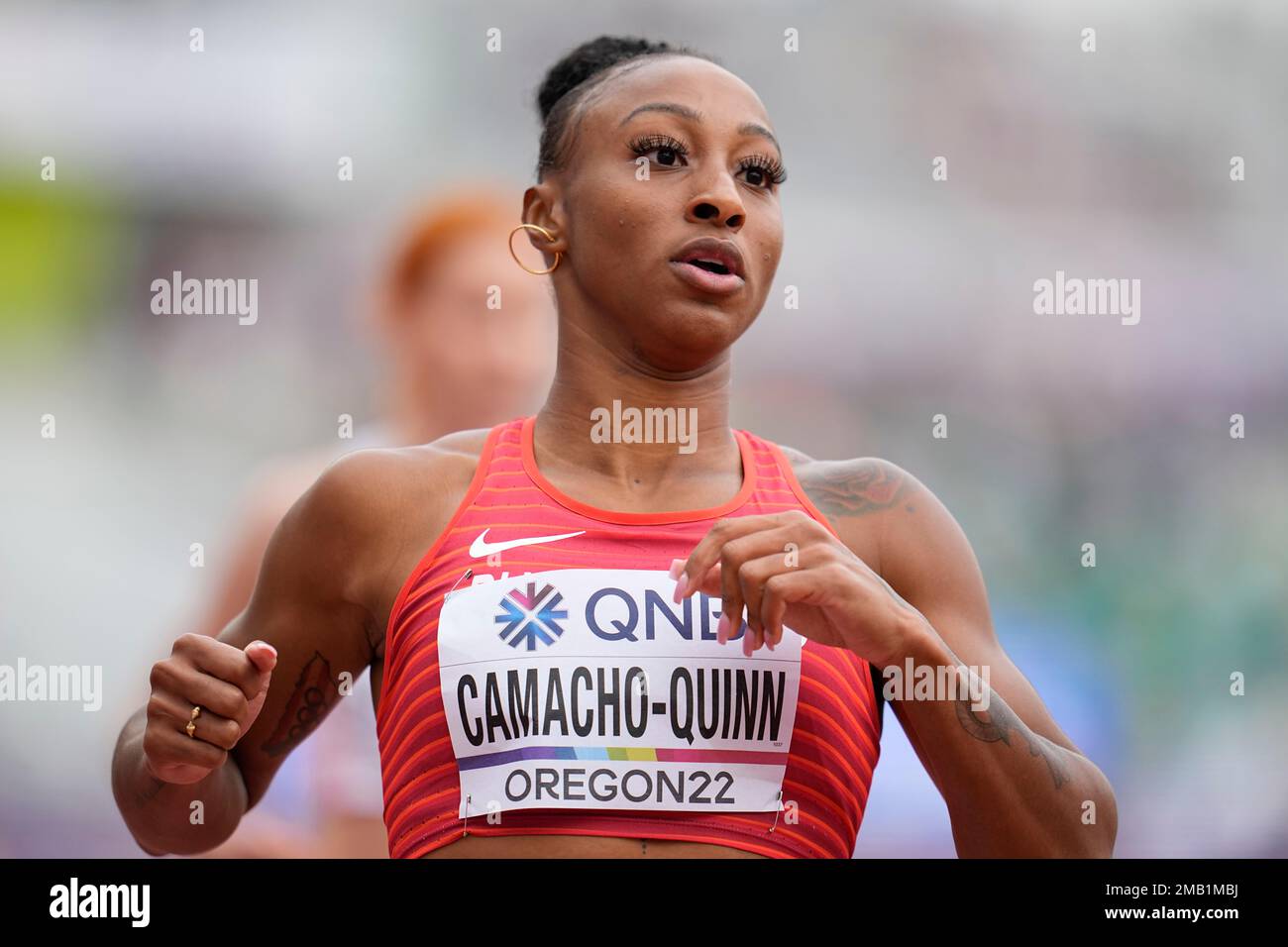Jasmine CamachoQuinn, of Puerto Rico, wins a heat in the women's 100