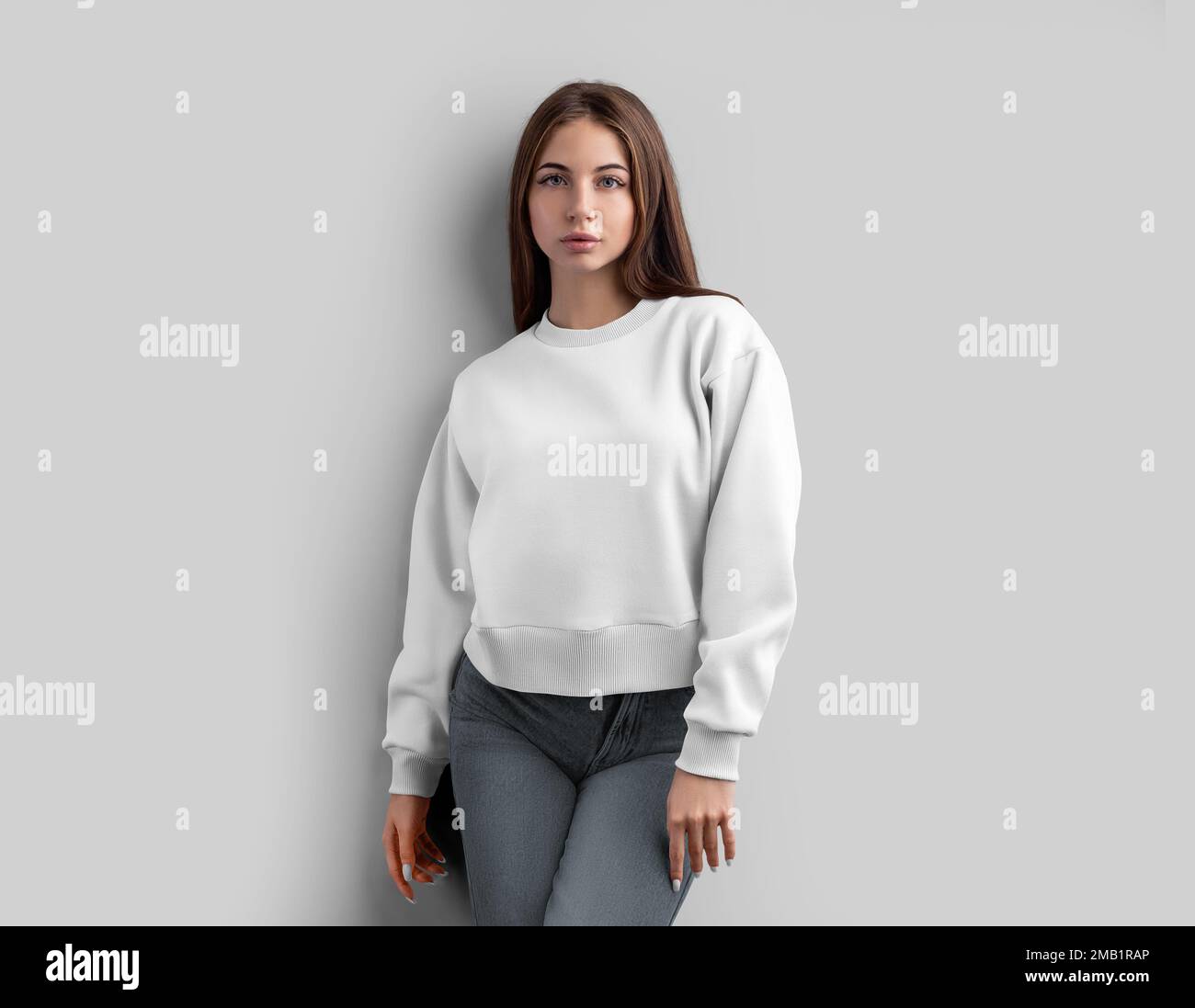 Template of a white crop shirt on a girl, looking straight ahead, a sweatshirt is isolated on the background, front view. Mockup women's apparel, clot Stock Photo