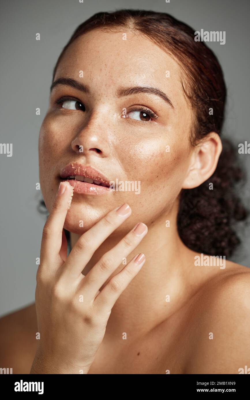 Sugar scrub, face and lips of woman in studio isolated on a gray