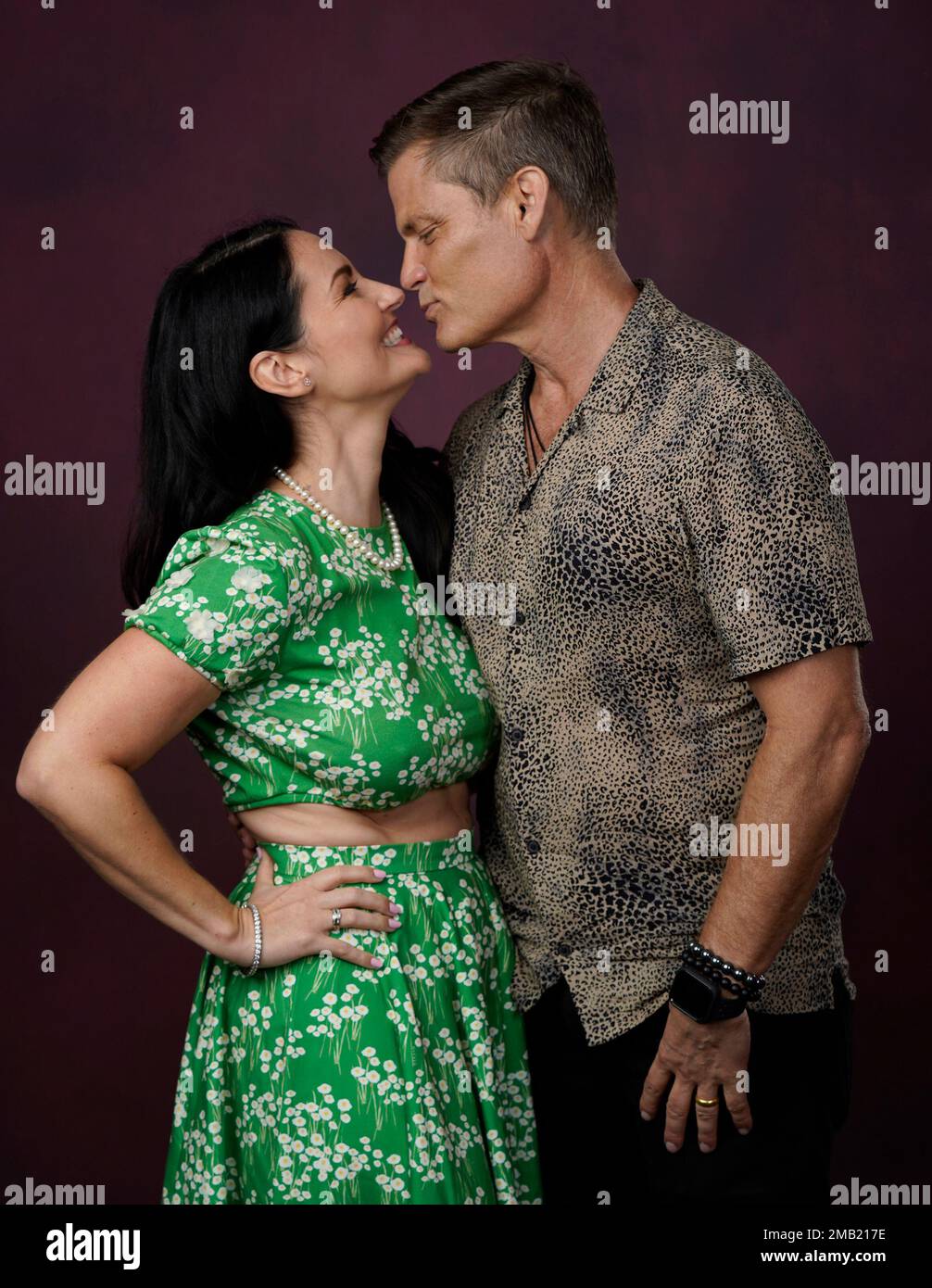 Jennifer Wenger, left, and Casper Van Dien kiss as they pose for a