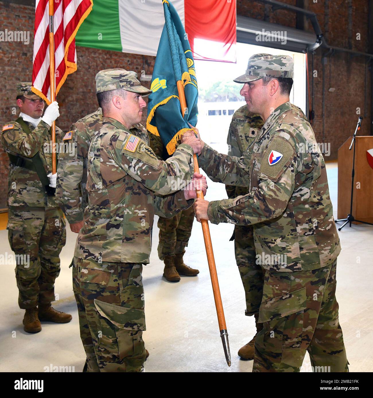 Col. Brad Bane, Commander 405th Army Field Support Brigade, passes the Army Field Support Battalion-Africa colors to Lt. Col. Alexander J. Amato, incoming Commander Army Fields Support Battalion-Africa during the change of command ceremony June 10 at Leghorn Army Depot, Italy. Stock Photo