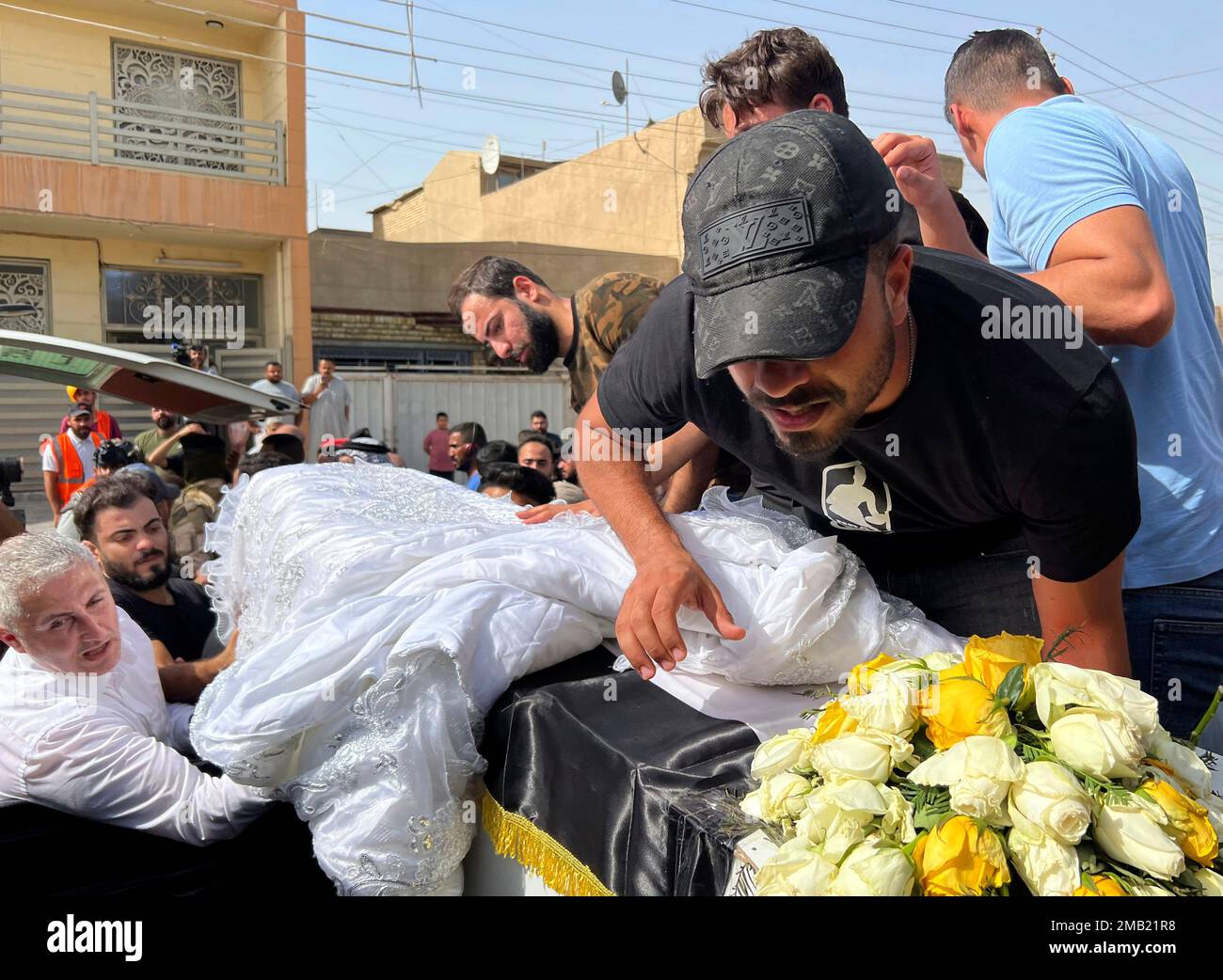 The coffin carrying Abbas Abdul Hussein, a 30-year-old victim of an  artillery strike, is received by his family in Baghdad, to later lay him to  rest in Najaf city, Thursday, July 21,