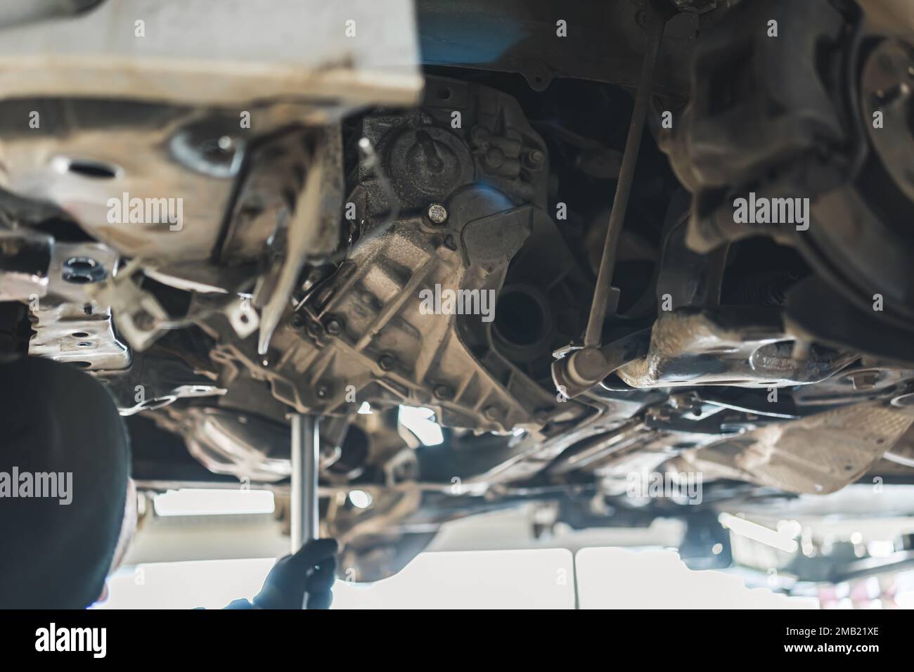 Mechanic replacing a clutch using various tools to remove and install a