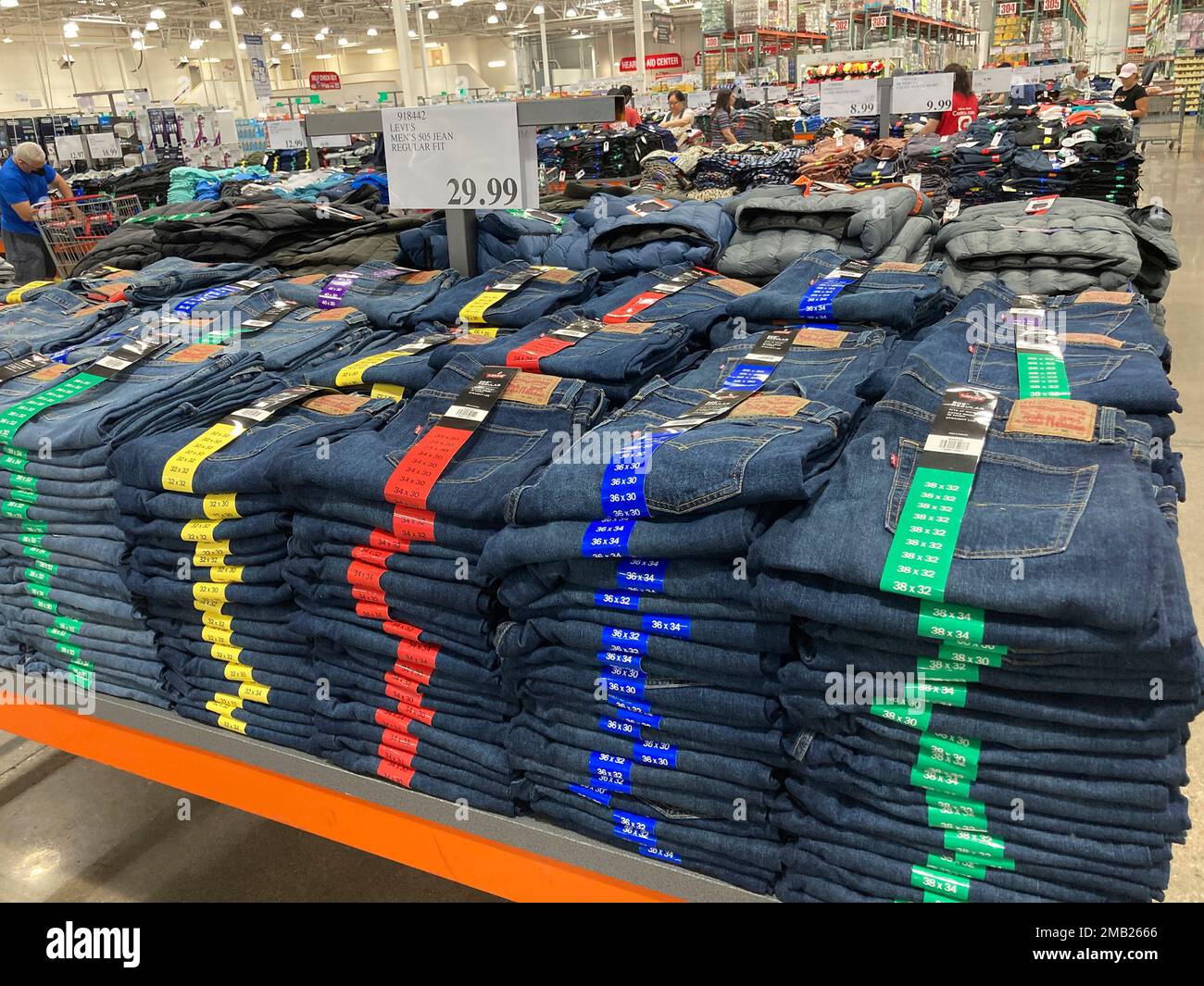 Stacks of Levi Strauss jeans are stacked on a display table in a Costco