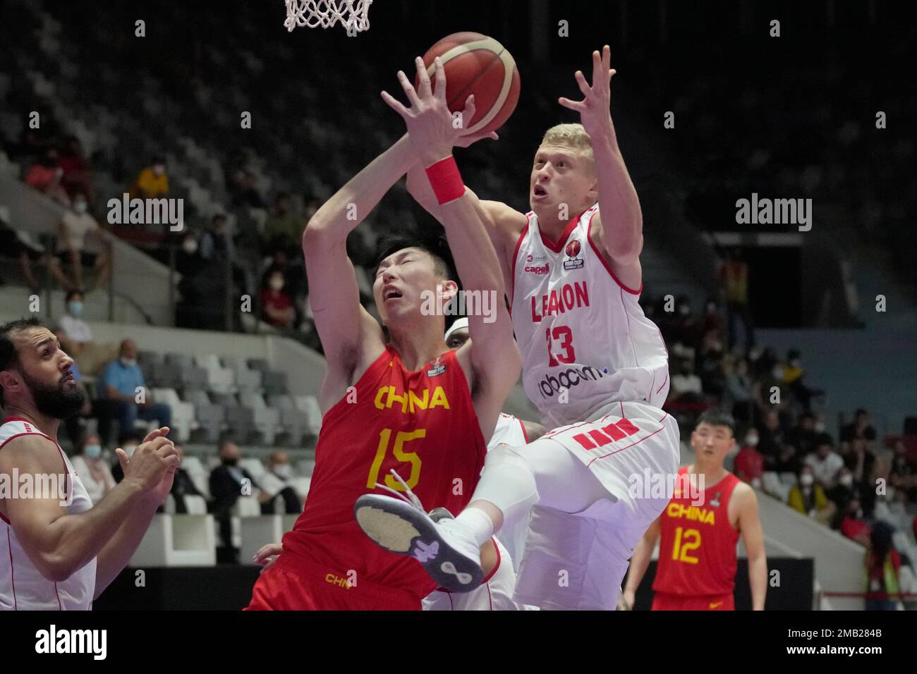China's Zhou Qi, left, battles for a rebound against Lebanon's Yousef  Khayat during their quarter final match at FIBA Asia Cup 2022 basketball  tournament in Jakarta, Indonesia, Wednesday, July 20, 2022. (AP