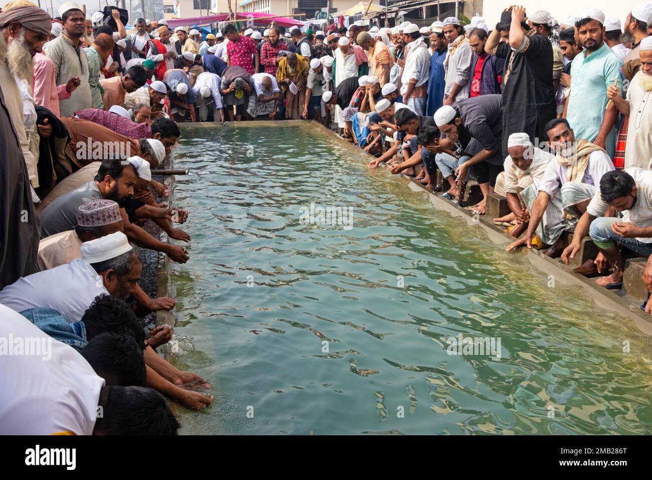 Dhaka, Bangladesh. 20th Jan, 2023. Muslim devotees gather to use water supplied during Bishwa Ijtema in Tongi, Dhaka, Bangladesh. The Bishwa Ijtema (Global Congregation) is an annual gathering of Muslims in Tongi, by the banks of the River Turag, on the outskirts of Dhaka, Bangladesh. It is the second largest congregation of the Muslim community after the pilgrimage to Mecca for the Hajj. The Ijtema is a prayer meeting spread over three days, during which attending devotees perform daily prayers while listening to scholars reciting and explaining verses from the Quran. Because of being non-pol Stock Photo