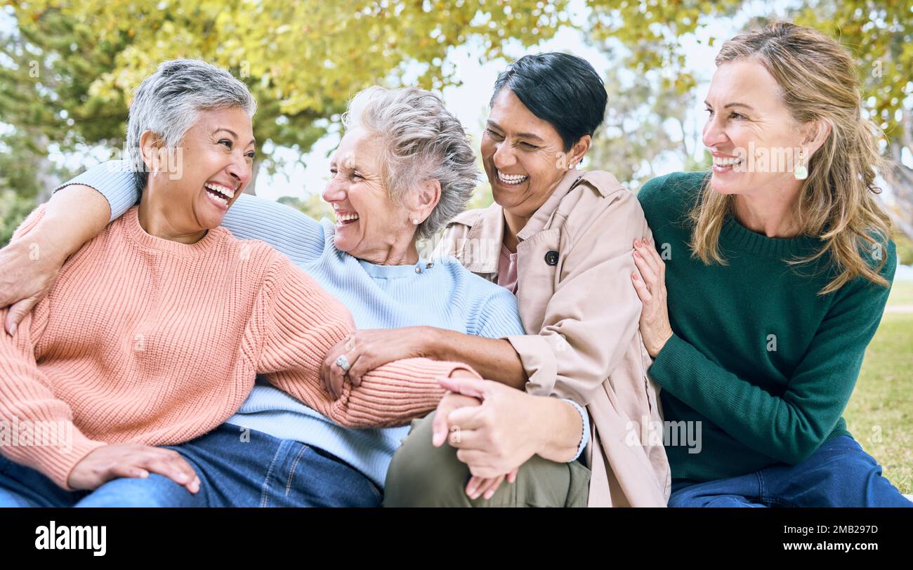 Happy senior women, laughing or bonding in nature park, grass garden or relax environment in retirement, support or trust. Smile, diversity or elderly Stock Photo