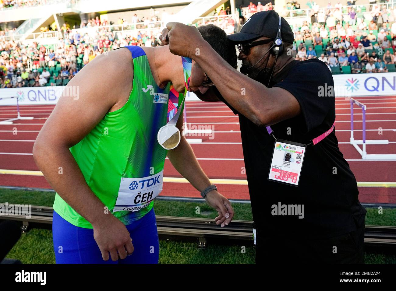 Wilbert Greaves gives Kristjan Ceh, of Slovenia, his gold medal after