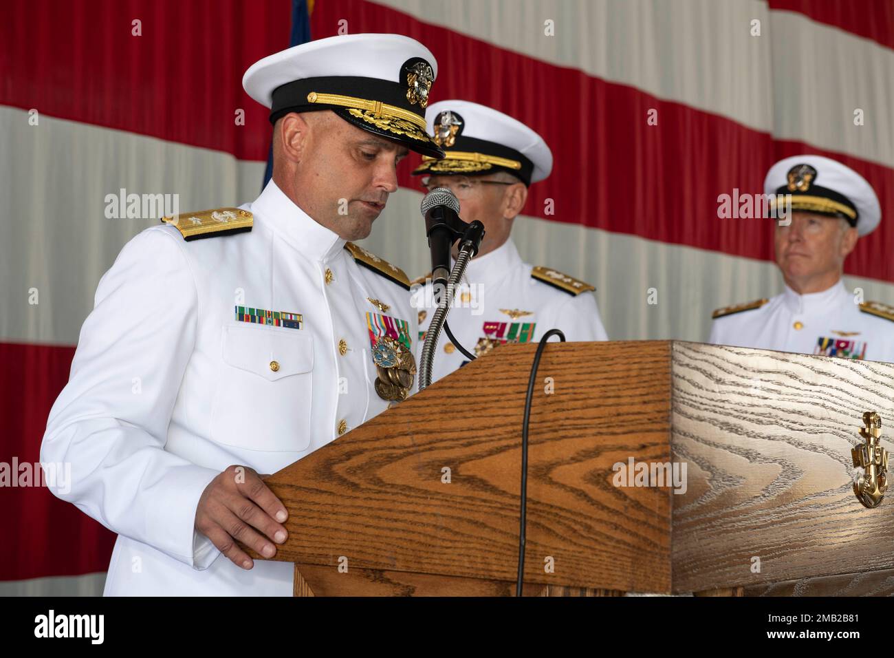 SAN DIEGO (Jun. 10, 2022) - Incoming Commander, Naval Air Force Reserve (CNAFR) Rear Adm. Brad Dunham reads his orders during the CNAFR change of command ceremony in the Fleet Logistics Support Squadron (VRC) 30 hangar at Naval Base Coronado, Jun. 10. CNAFR mans, trains and equips the Naval Air Force Reserve in order to provide enduring operational support and strategic depth to Navy forces that win in combat. Stock Photo