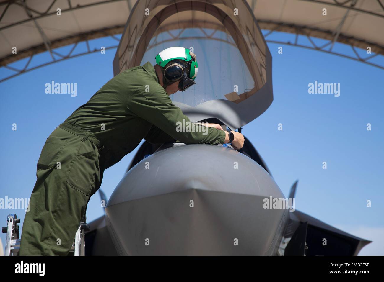 U.S. Marine Corps Lance Cpl. Logan Runnells, a fixed-wing aircraft mechanic with Marine Fighter Attack Squadron (VMFA) 122, 13th Marine Expeditionary Unit, inspects the nose of an F-35B Lightning II during Realistic Urban Training exercise at Marine Corps Air Station Yuma, Arizona, June 9, 2022. The purpose of RUT is to enhance the integration and collective capability of the MEU's command, air, ground, and logistics elements and prepare the 13th MEU to meet the nation's crisis response needs during its upcoming overseas deployment. Stock Photo