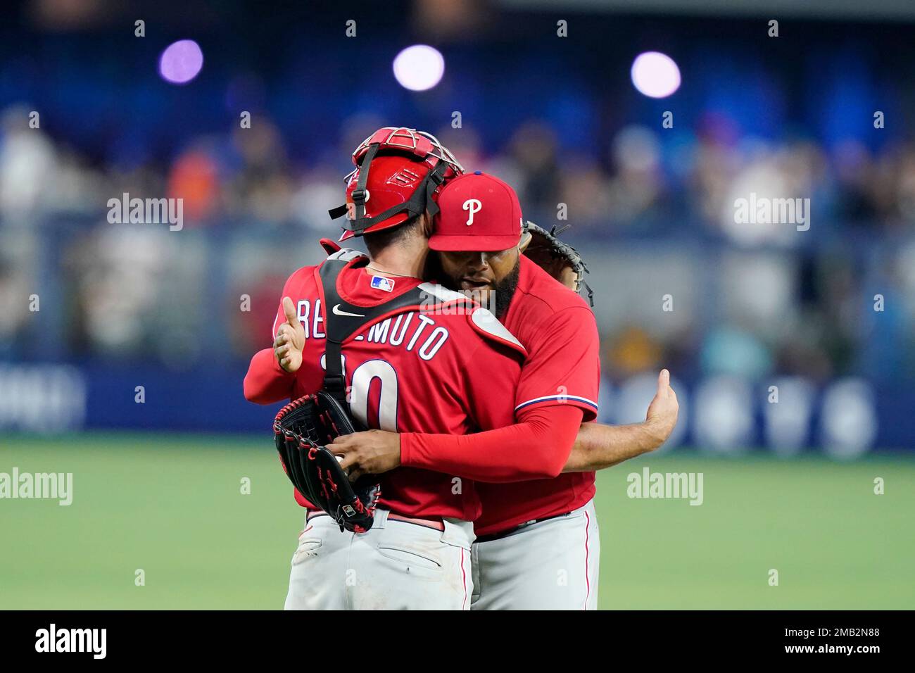Philadelphia Phillies catcher J.T. Realmuto, left, hugs relief pitcher