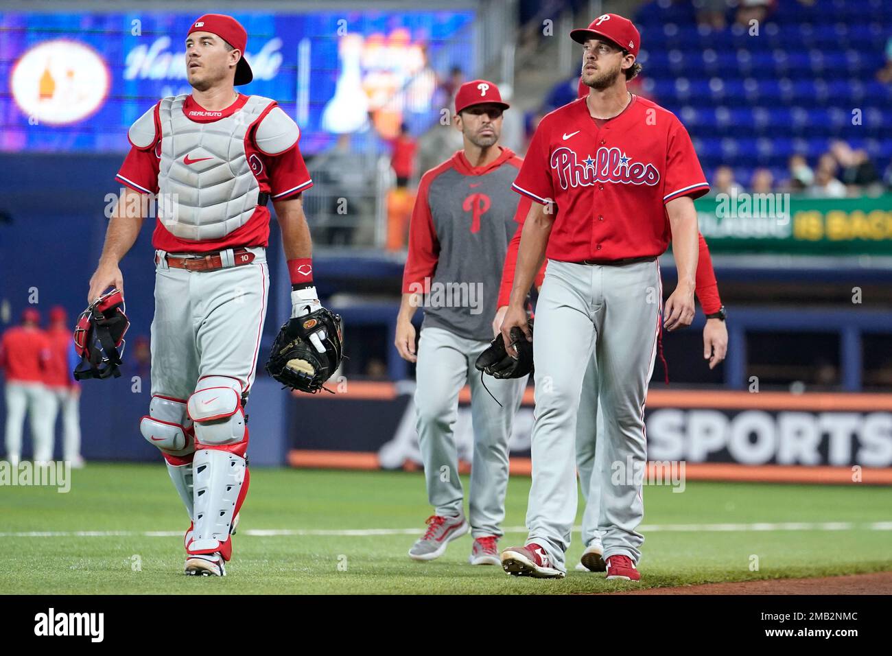 Philadelphia Phillies catcher J.T. Realmuto, left, and starting pitcher Aaron  Nola, right, walk to the dugout before a baseball game against the Miami  Marlins, Sunday, July 17, 2022, in Miami. (AP Photo/Lynne