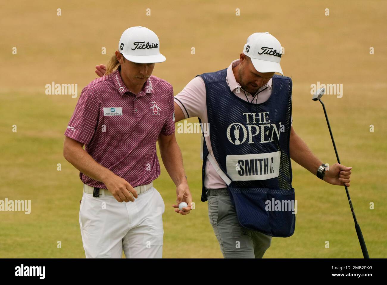 Cameron Smith, of Australia, walks off the 18th green with his caddie