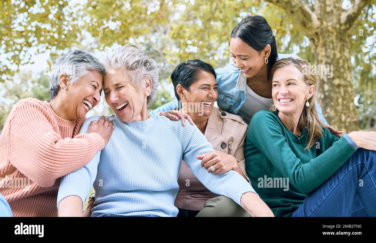 Happy senior friends, laughing or bonding in nature park, grass garden or relax environment in retirement, support or trust. Smile, diversity or Stock Photo