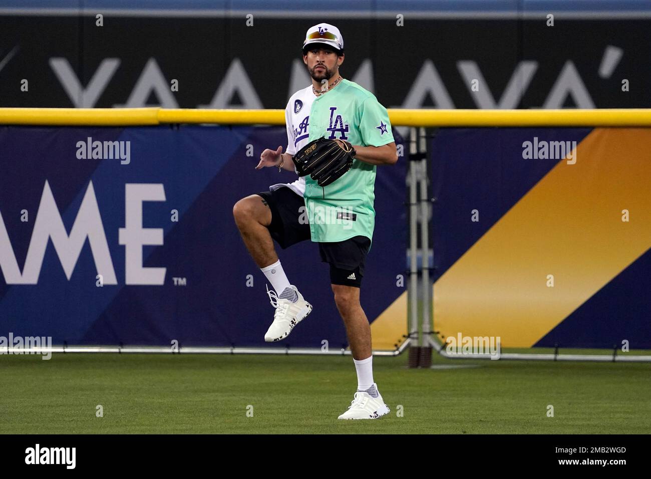 Rapper and singer Bad Bunny runs in the outfield during the MLB All
