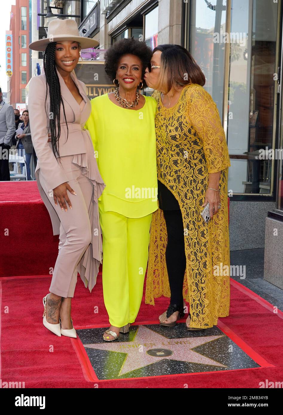 Actor Jenifer Lewis, center, poses with guests Brandy, left, and Roz