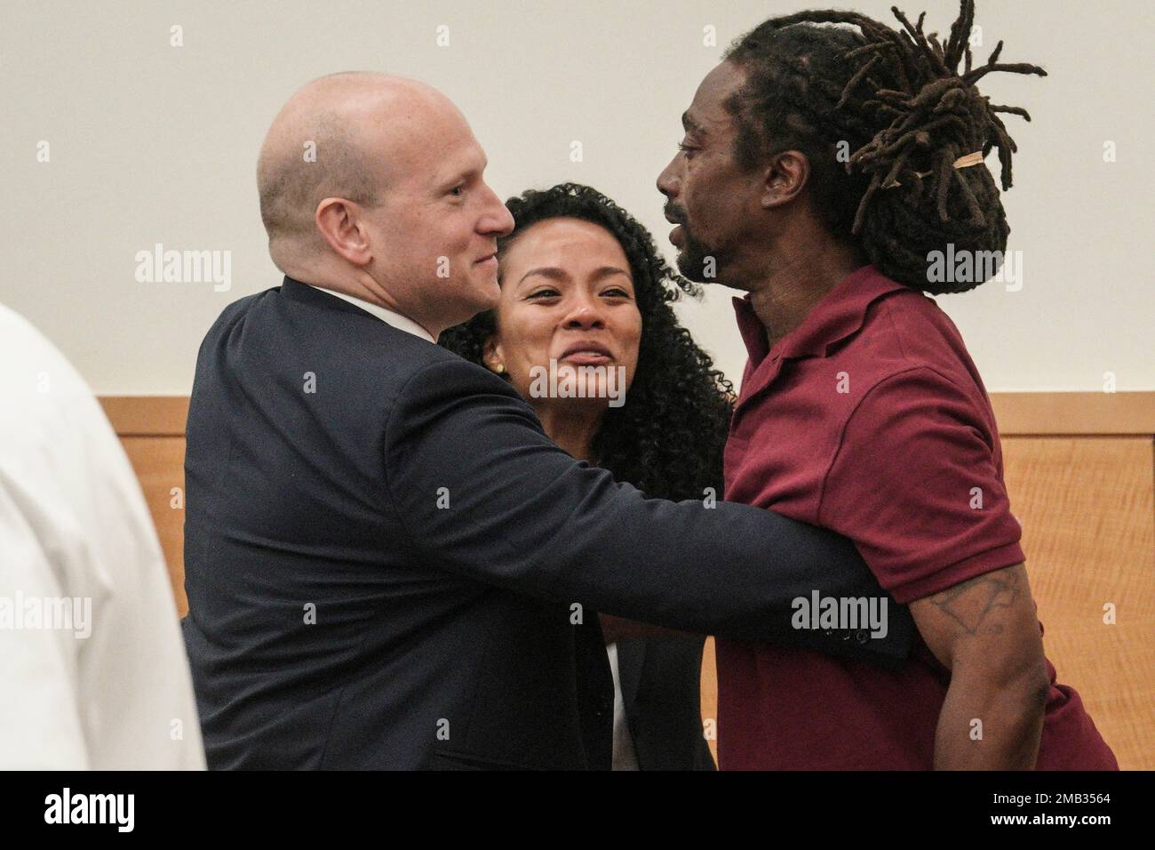 James Irons, right, is embraced by his lawyers David Shanies, left, and