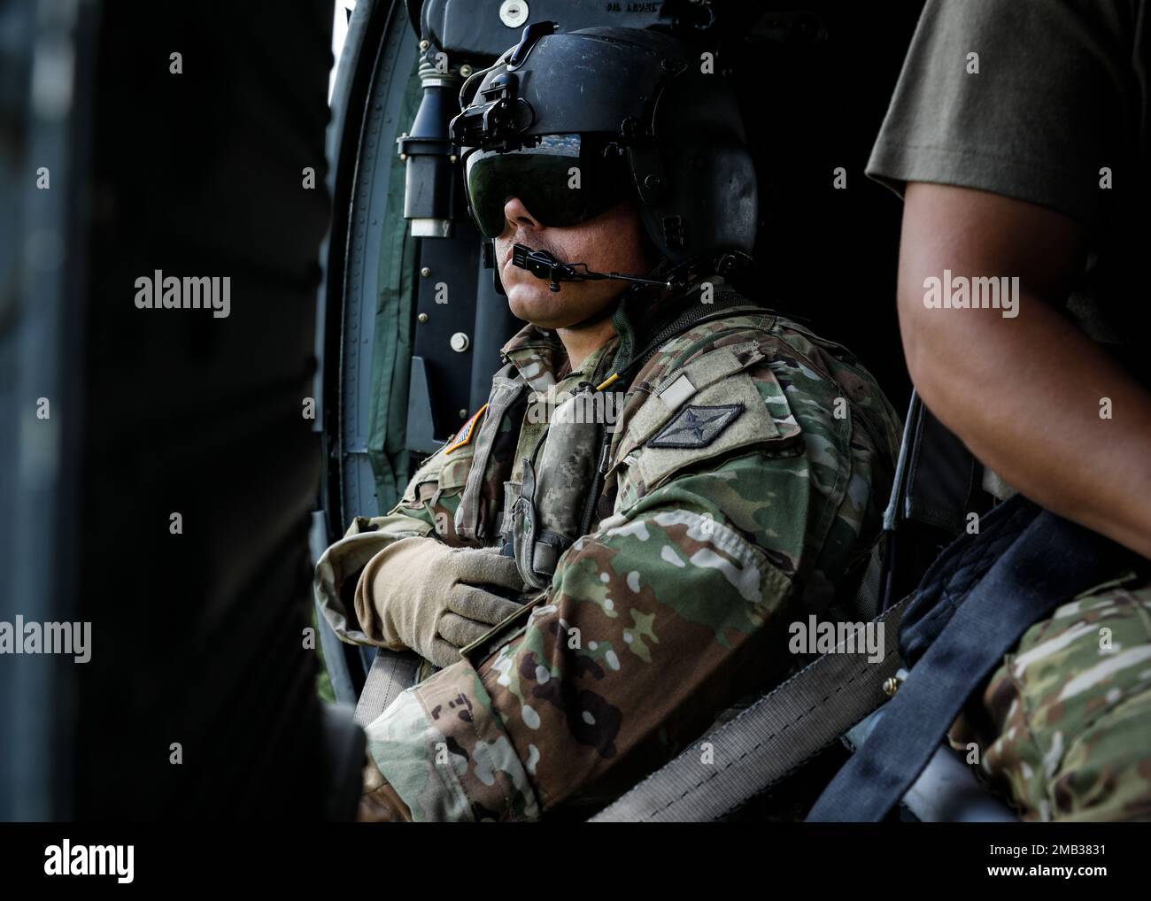 Staff Sgt. Nicholas Metheny, Loadmaster for the Medical Evacuation Crew from G Company 3-238th General Support Aviation Battalion, oversees Fort Chaffee from the air in a routine orientation flight.  Metheny and his crew support Arkansas National Guard units participating in annual training by checking units' locations, training areas, firing ranges, and for potentially hazardous areas; the information gathered is then cross-referenced with their area maps. By conducting these daily flights, the crew can stay prepared to aid during natural disasters or instances where individuals are injured i Stock Photo