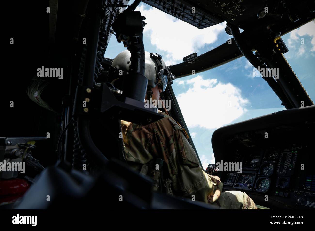 Staff Sgt. Nicholas Metheny, Loadmaster for the Medical Evacuation Crew from G Company 3-238th General Support Aviation Battalion, oversees Fort Chaffee from the air in a routine orientation flight. Metheny and his crew support Arkansas National Guard units participating in annual training by checking units' locations, training areas, firing ranges, and for potentially hazardous areas; the information gathered is then cross-referenced with their area maps. By conducting these daily flights, the crew can stay prepared to aid during natural disasters or instances where individuals are injured in Stock Photo