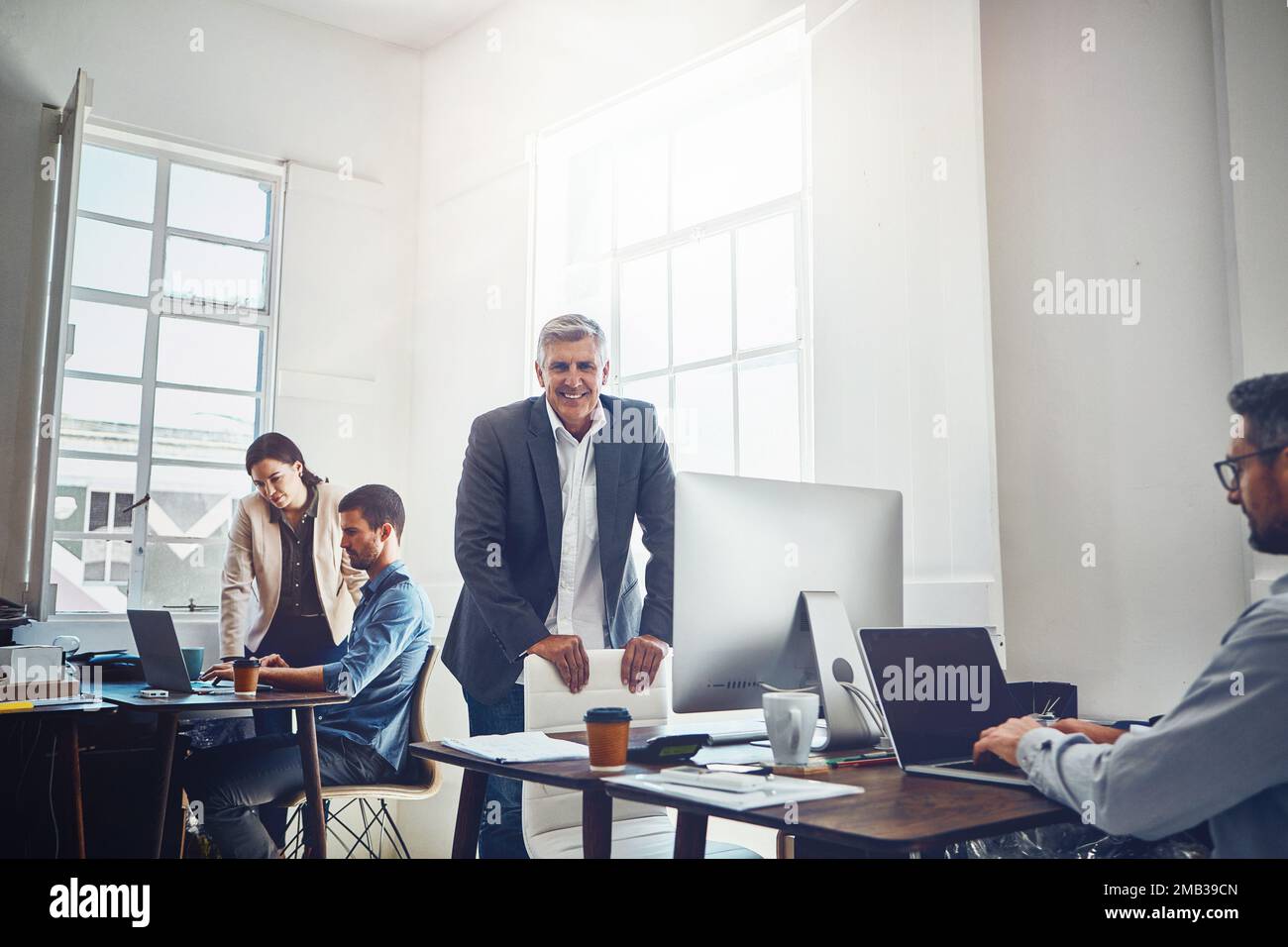 Leadership, teamwork and portrait of business man in office workplace ...