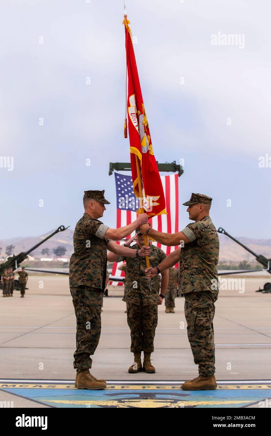 U.S. Marine Lt. Col. Stephen W. Borrett, the incoming commanding officer for Headquarters and Headquarters Squadron, Marine Corps Air Station Camp Pendleton, receives the organizational colors from Lt. Col. Frank A. Savarese, the outgoing commanding officer for H&HS, during a change of command ceremony on MCAS Camp Pendleton, California, June 10, 2022. Savarese commanded H&HS as it made history by becoming a flying squadron for the first time in the unit’s existence. The Marines of H&HS support other Camp Pendleton units with their airlift capabilities and ability to transport critical personn Stock Photo