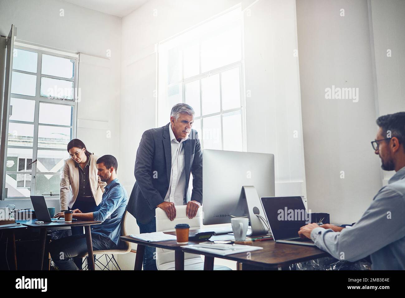 Teamwork, productivity and business people at desk with computer for project, planning and email. Corporate workplace, startup agency and employees Stock Photo