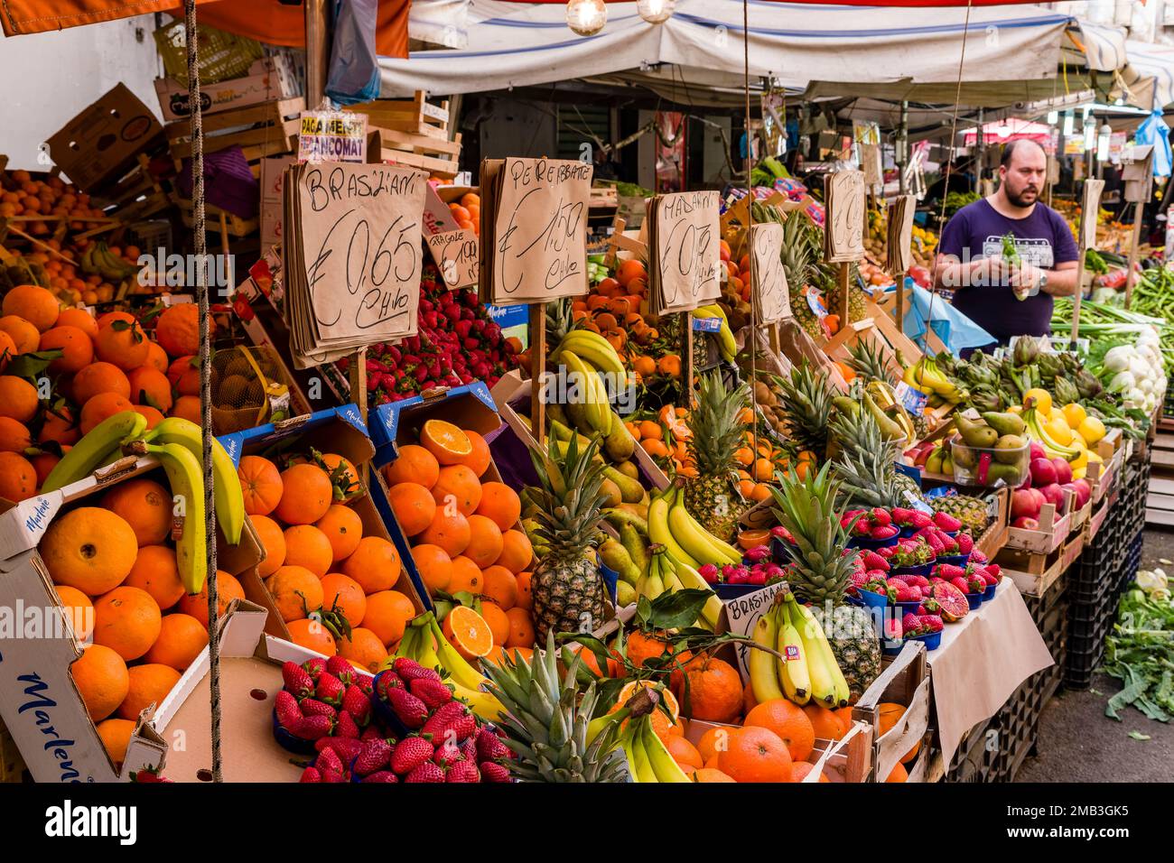 All kinds of fruits and vegetables are displayed for sale in the local Ballaro market. Stock Photo