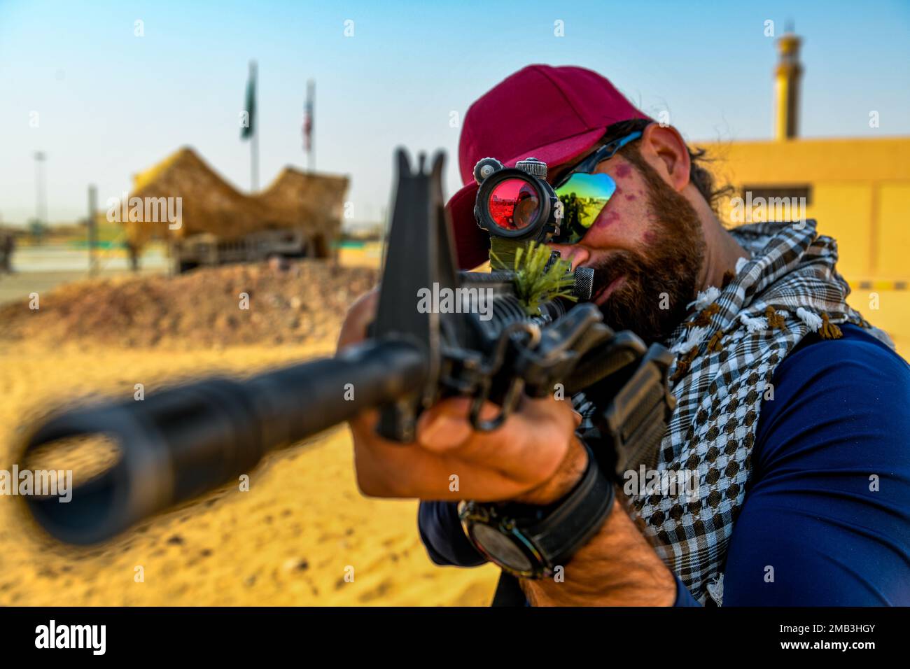 A U.S. Army translator looks down the barrel of an M4 carbine during a platoon immersion in Al-Kharj, Kingdom of Saudi Arabia, June 10, 2022. The immersion was a training event meant to build interoperability between the U.S Army and Royal Saudi Land Force at the platoon level while enhancing both U.S. and partner nation skillsets. Stock Photo