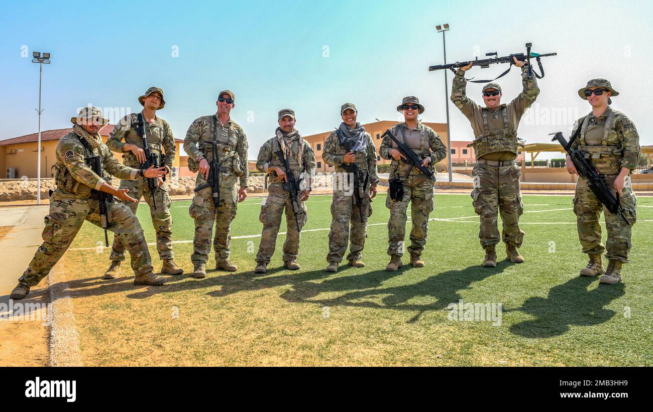 U.S. Air Force Staff Sgt. Alejandro Bachelier, Senior Airman Andrew Monroe, Tech. Sgt. Michael Adams, Staff Sgt. Jaime Yohance, Staff Sgt. Kayla Pelaez, Staff Sgt. Jennifer Castillo, Senior Airman Zachary Fooks and Airman 1st Class Kahrie Balding, assigned to the 378th Expeditionary Security Forces Squadron, pose for a group photo, in Al-Kharj, Kingdom of Saudi Arabia, June 10, 2022. Eight USAF Defenders were invited by the U.S. Army to attend Task Force Hurricane’s platoon immersion course alongside the Royal Saudi Land Force. The immersion allowed the 378th ESFS members a chance to develop a Stock Photo