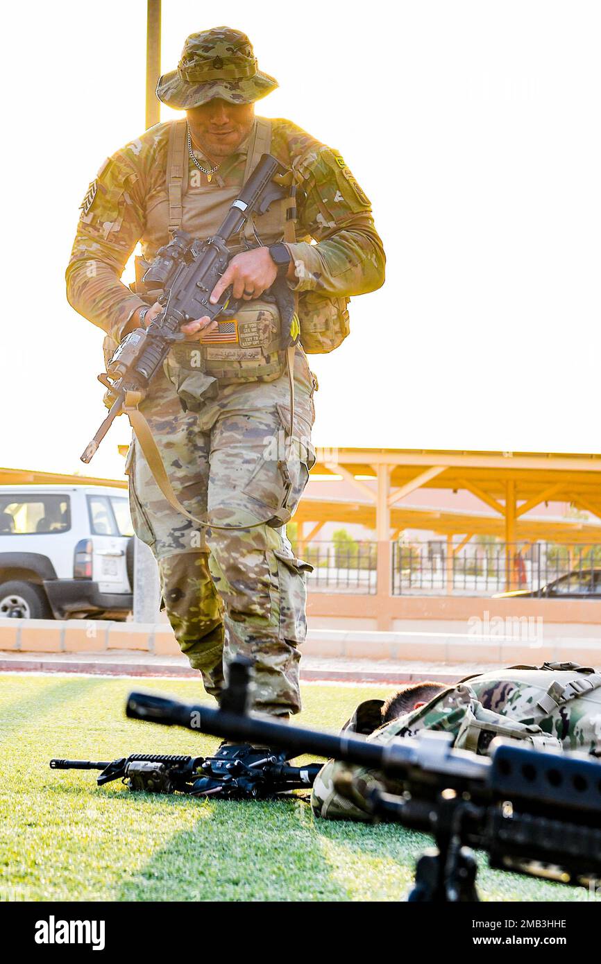 A U.S. Soldier assigned to Task Force Hurricane from the 1st Battalion, 124th Infantry Regiment, disarms a mock combatant during a platoon immersion in Al-Kharj, Kingdom of Saudi Arabia, June 10, 2022. The immersion was a training event meant to build interoperability between the U.S Army and Royal Saudi Land Force at the platoon level while enhancing both U.S. and partner nation skillsets. Stock Photo