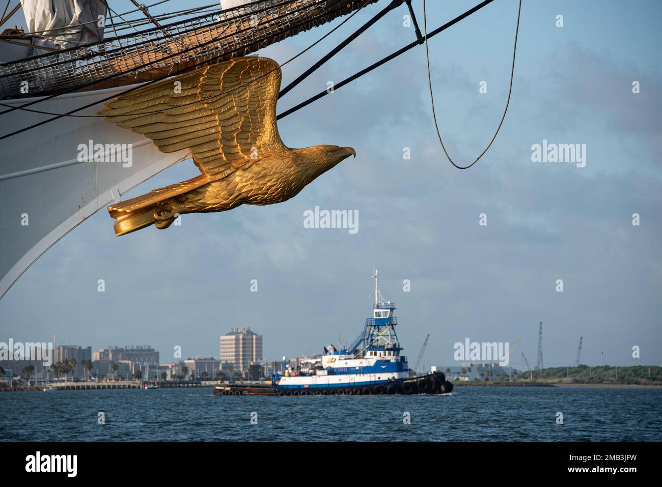 The masthead of Coast Guard Cutter Eagle appears to soar over a nearby